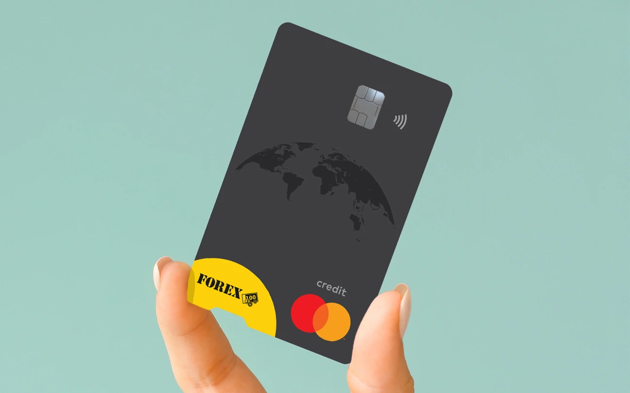 Hand holding a black FOREX Credit Card with Mastercard logo against a turquoise background.